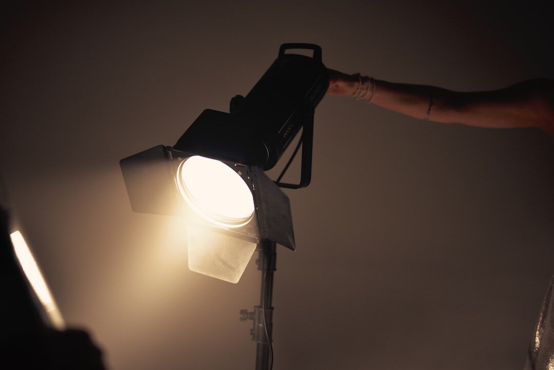 Lighting designer adjusting a studio spotlight