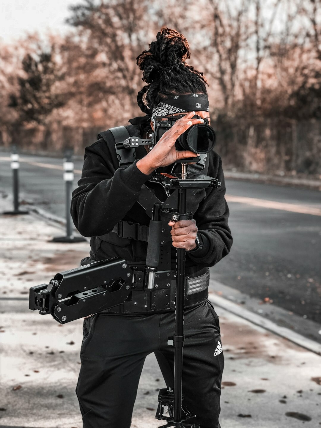 Camera operator carrying a camera on his shoulder