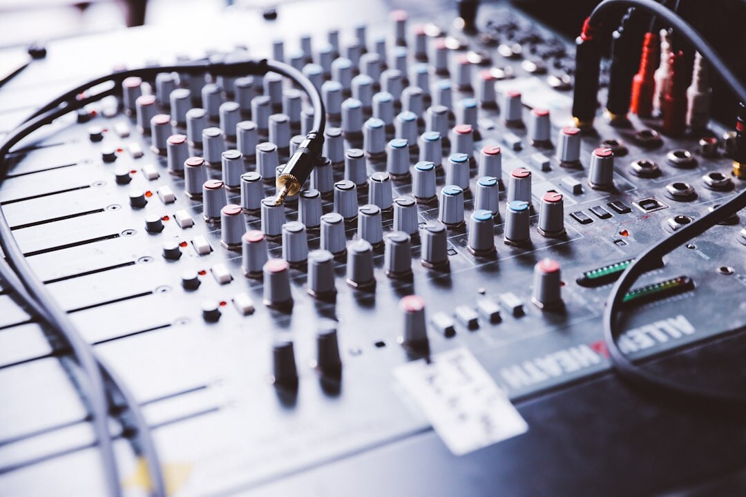 Audio mixing console with sliders and meters